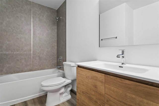 full bathroom with vanity, bathing tub / shower combination, hardwood / wood-style flooring, and toilet