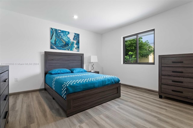 bedroom with hardwood / wood-style flooring