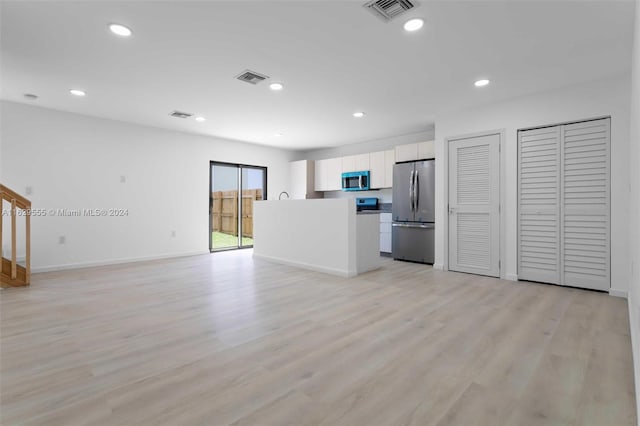 unfurnished living room with light wood-type flooring