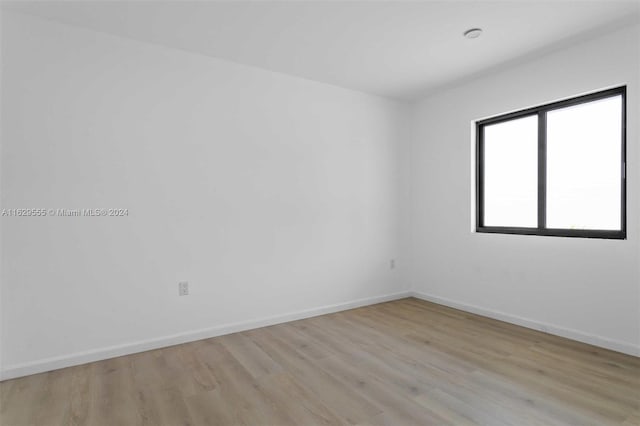 unfurnished room with light wood-type flooring