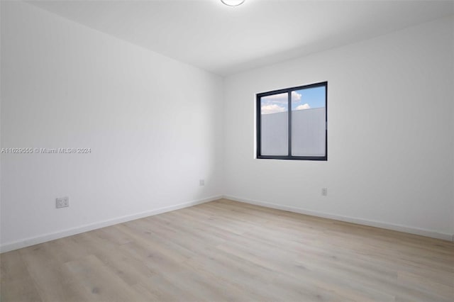 unfurnished room with light hardwood / wood-style floors