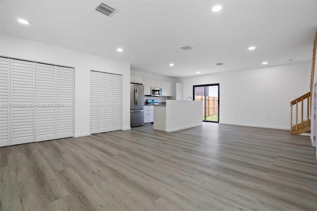 unfurnished living room with light wood-type flooring