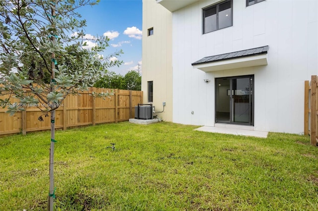 exterior space with a lawn and central AC unit