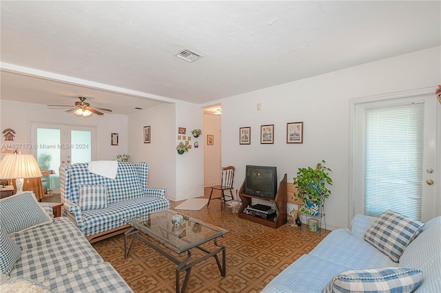 living area featuring a ceiling fan, a wealth of natural light, and visible vents