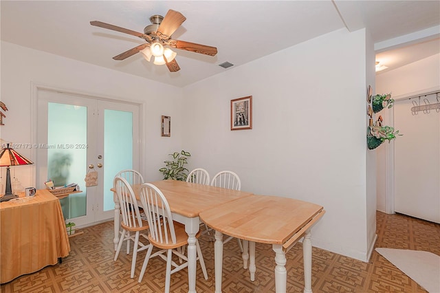 dining room featuring ceiling fan, visible vents, baseboards, french doors, and light floors