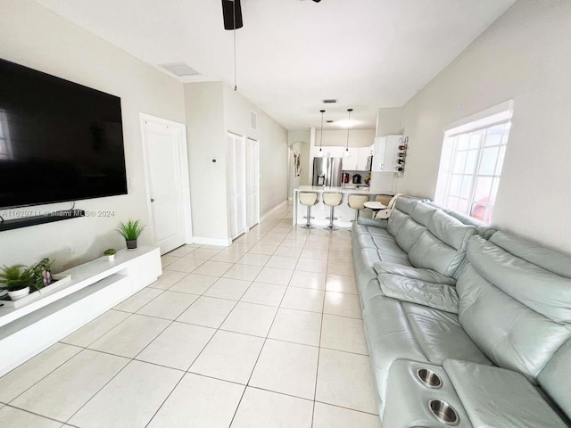 tiled living room featuring ceiling fan