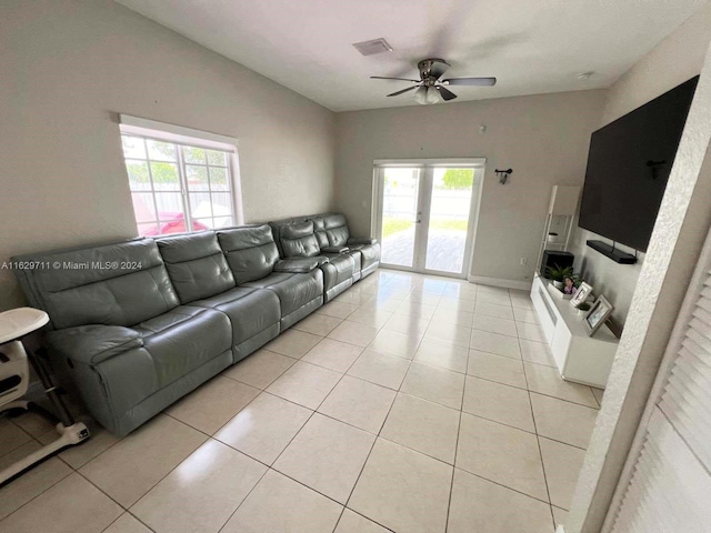 tiled living room with french doors and ceiling fan