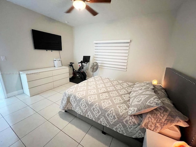 tiled bedroom featuring ceiling fan