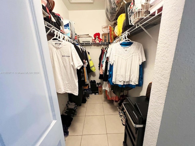 spacious closet featuring light tile patterned floors