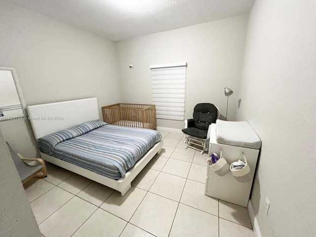 bedroom featuring light tile patterned floors