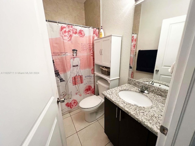 bathroom with tile patterned flooring, vanity, and toilet