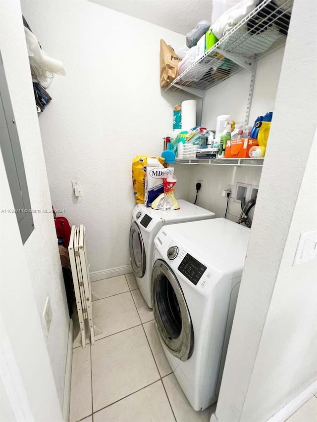 washroom featuring washer and clothes dryer and light tile patterned floors