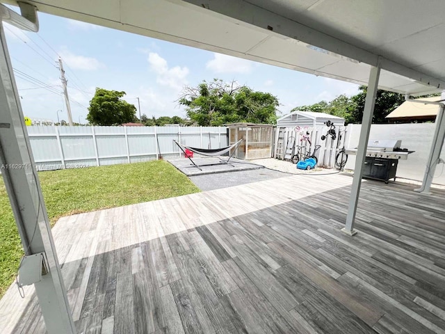 wooden deck with a lawn