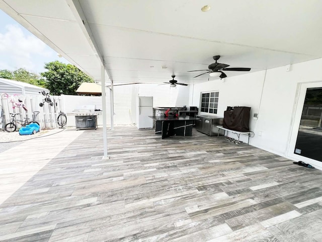 view of patio with a wooden deck and ceiling fan