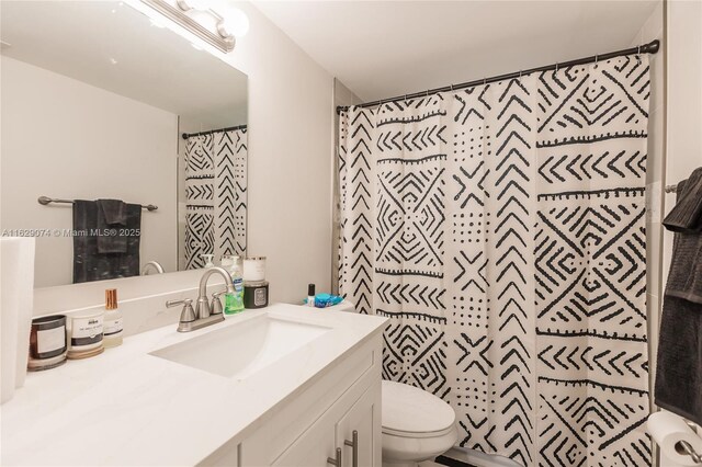 bathroom featuring vanity, toilet, and a shower with shower curtain