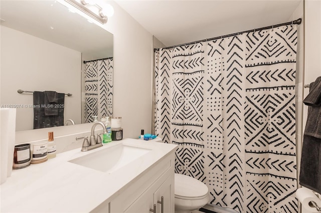 bathroom with vanity, curtained shower, and toilet