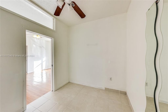 unfurnished room featuring light tile patterned flooring and ceiling fan