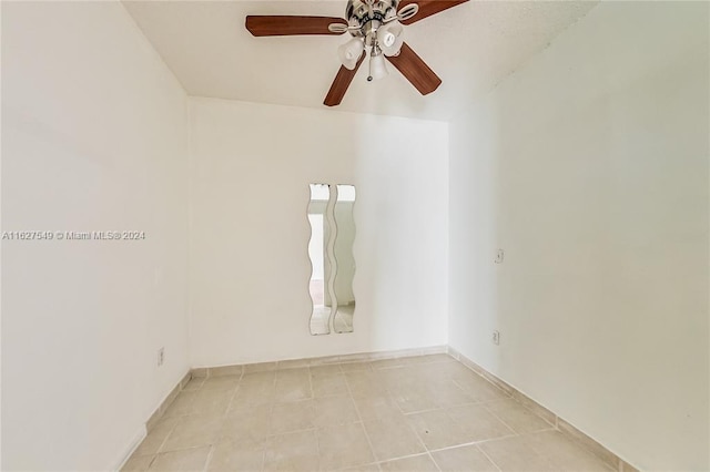 tiled empty room featuring ceiling fan