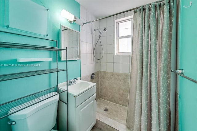 bathroom featuring walk in shower, toilet, and vanity