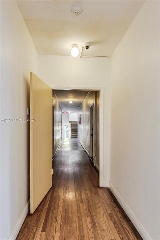 corridor featuring dark wood-type flooring