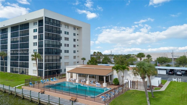 view of swimming pool featuring a patio and a yard