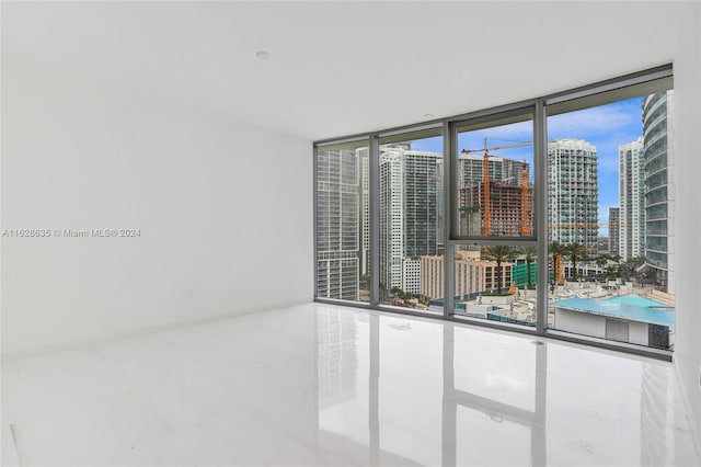 empty room with a healthy amount of sunlight and expansive windows