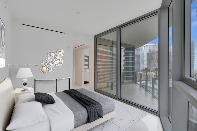 bedroom featuring access to outside and floor to ceiling windows