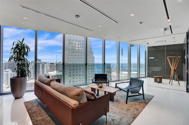 living room with a water view, floor to ceiling windows, and a wealth of natural light