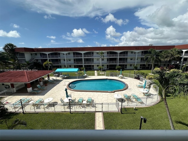 view of pool featuring a patio and a lawn