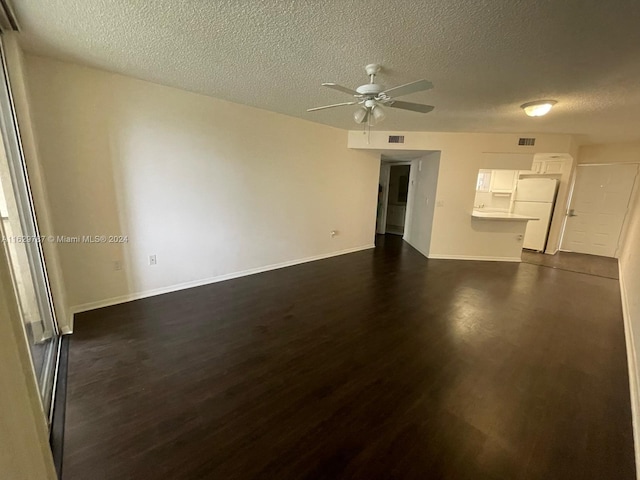 interior space featuring a textured ceiling, dark hardwood / wood-style flooring, and ceiling fan