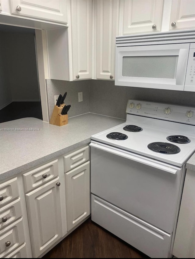 kitchen featuring white cabinets, white appliances, and dark hardwood / wood-style floors