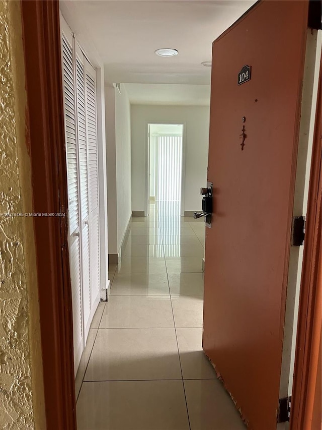 corridor with light tile patterned floors