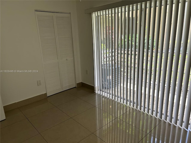 unfurnished bedroom featuring a closet and tile patterned flooring