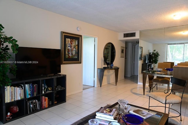 living room with light tile patterned floors and a textured ceiling