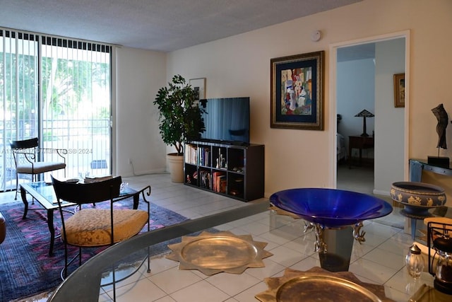 tiled living room featuring a wall of windows