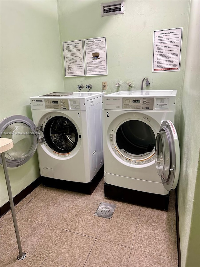 washroom with washer and dryer