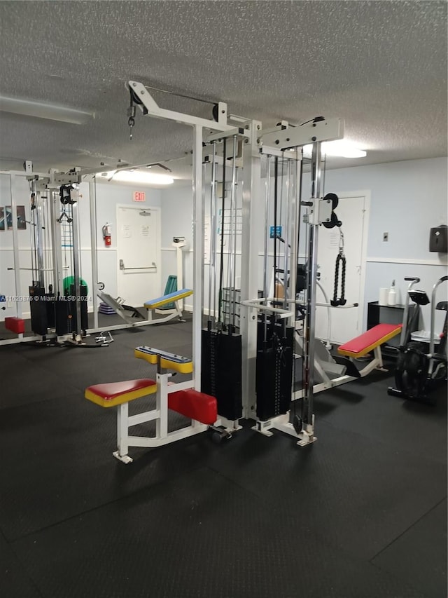 workout area featuring a textured ceiling