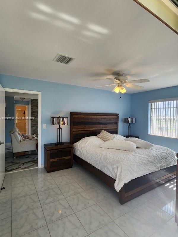 bedroom with light tile patterned flooring and ceiling fan