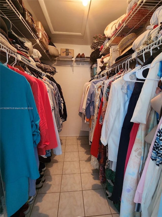 walk in closet with tile patterned floors