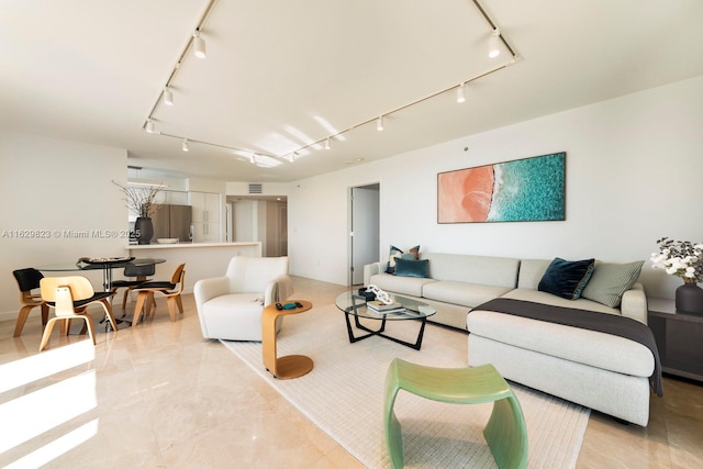 living area featuring marble finish floor, visible vents, and track lighting