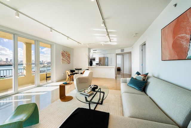 living room featuring a view of city, visible vents, and track lighting