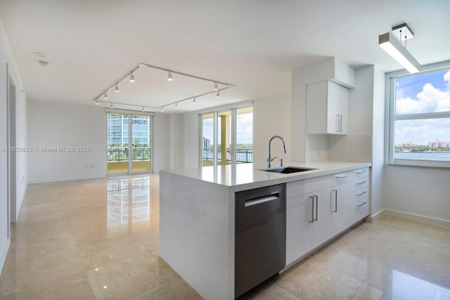 kitchen featuring light countertops, white cabinets, a sink, modern cabinets, and dishwasher