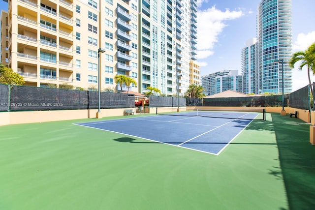 view of sport court featuring a view of city, community basketball court, and fence