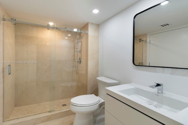 full bath with visible vents, a shower stall, toilet, and vanity