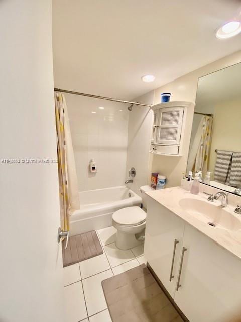 full bathroom featuring toilet, shower / bath combo with shower curtain, vanity, and tile patterned flooring