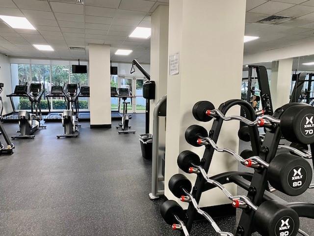 gym with a paneled ceiling