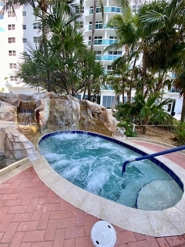 view of pool with a community hot tub