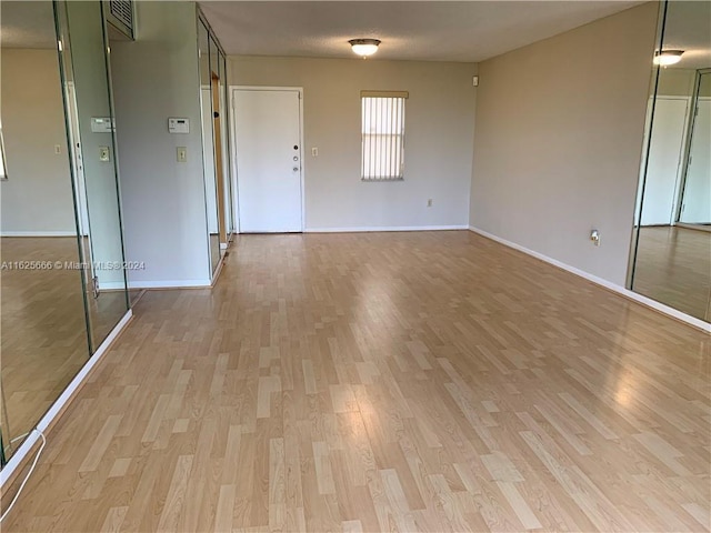 empty room with light wood-type flooring