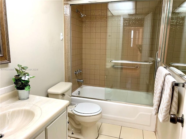 full bathroom with shower / bath combination with glass door, vanity, tile patterned flooring, and toilet