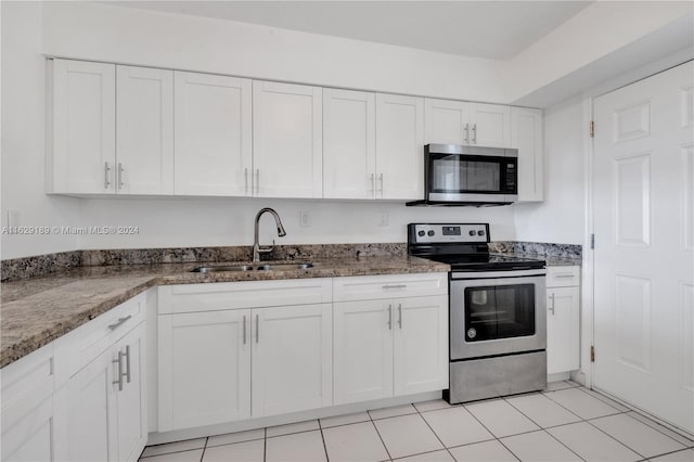 kitchen with appliances with stainless steel finishes, white cabinetry, and sink